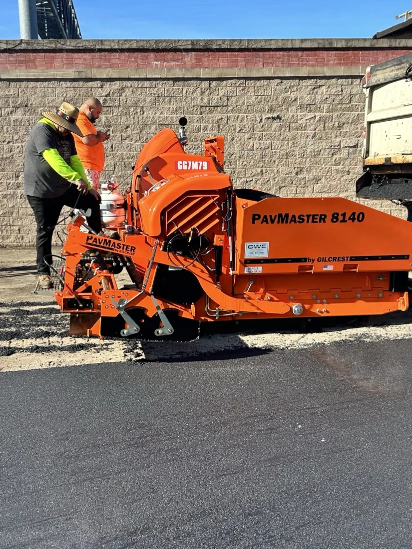 Rich's Paving crew running the asphalt paver on a commercial lot