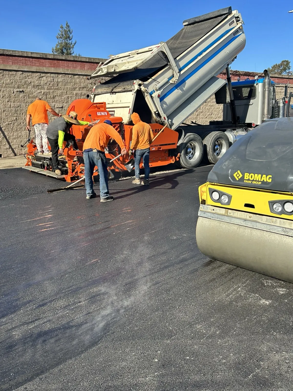 Rich's Paving crew laying hot asphalt with paver and roller